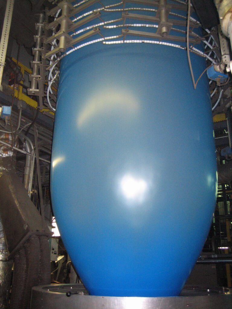 A blue balloon is in the middle of an assembly line.