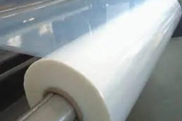 A roll of plastic film is being rolled.
