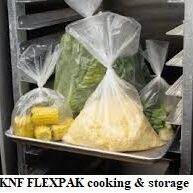 A tray of vegetables in a container with plastic bags.